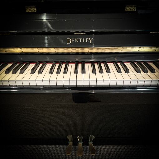 Detail of Bentley Logo on used upright piano