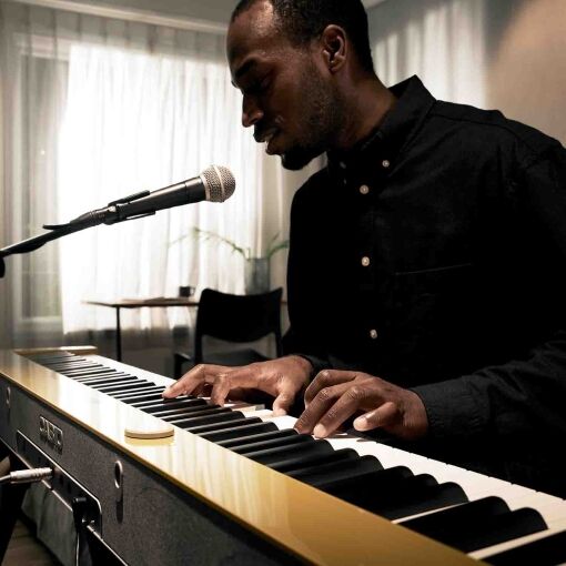 Man playing PX-S7000 in his living room