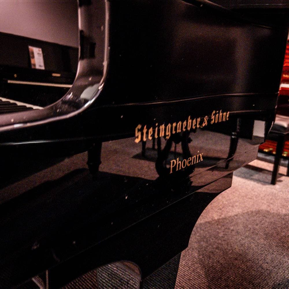 Used Steingraber Opus 168 Grand Piano in Polished Ebony side logo