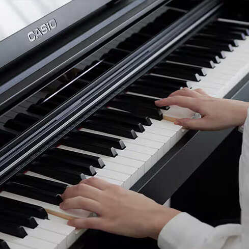 A Casio AP-S450 being played by a young person, showing just the keys and hands.